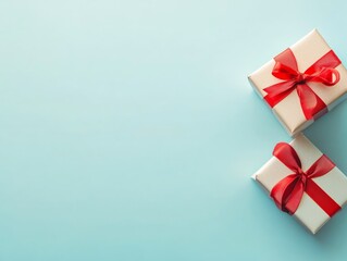 Two white boxes with red bows on top of a blue background