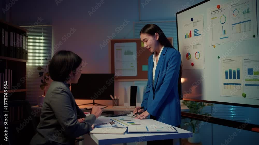 Aufkleber businesswoman in a blue suit stands in front of a whiteboard, explaining charts and discussing data 