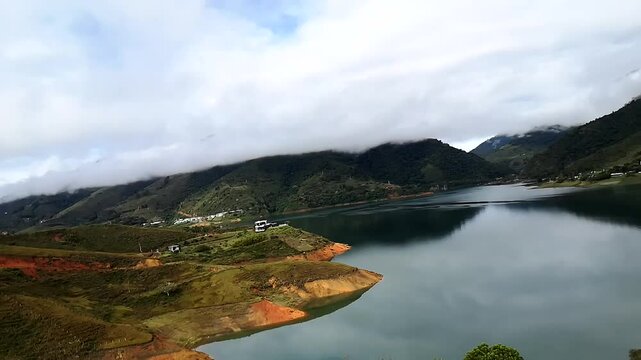 Time-Lapse of Lake Calima in Valle del Cauca, Colombia, with Moving Clouds Reflecting on the Tranquil Water, Capturing the Scenic Beauty of Nature and the Dynamic Passage of Time in a Serene Setting
