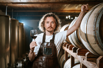 Winemaker Inspecting Red Wine in Cellar