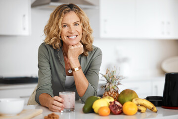 Mature woman, smoothie and portrait in kitchen with smile for nutrition, wellness and meal prep in home. Person, fruit and happy for drink, detox and gut health with ingredients at house in France