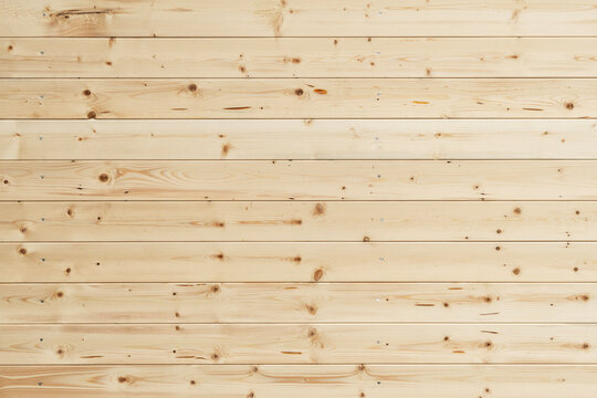 Smooth light wooden panels with texture and knots, laid horizontally, ideal for background use