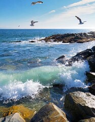 Clear Ocean Waves Gently Crashing on a Rocky Shoreline, With Sea Spray Glittering in the Bright Sunlight, and Seagulls Soaring Above the Deep Blue Waters in a Calm Coastal Setting