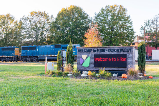 ELKIN, NORTH CAROLINA, USA-14 OCTOBER 2022: Monument sign-Welcome to Elkin, Yadkin Valley, with train locomotive behind.