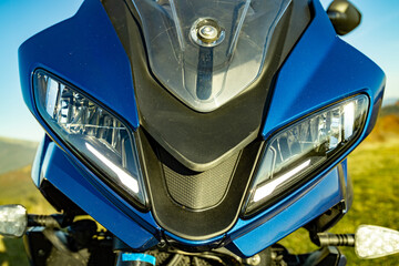 Front view of a motorcycle with mountains in the background.