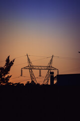 The sunset with an electrical tower in front