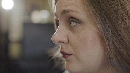 A candid look at a woman discussing body positivity and self-acceptance during a community event in a local venue