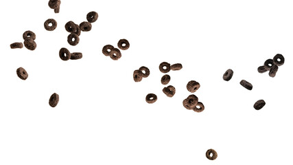 Chocolate rings cereal spill out into a bowl. Breakfast.