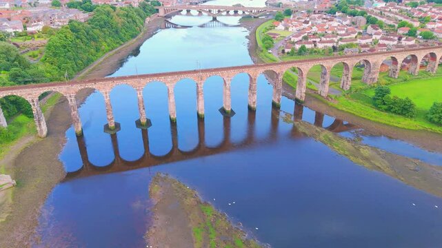 Berwick, Northumberland, UK, June 19, 2024; sunset aerial orbit clip high to low level of the Royal Border Bridge Viaduct, Berwick, Berwick-upon-Tweed, Northumberland, England, UK.