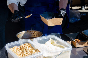 Close-up of the process of cooking food in an outdoor open kitchen