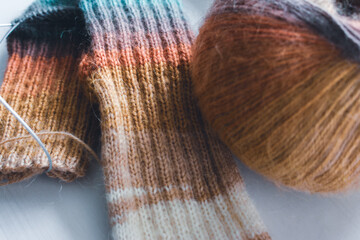 Knitted socks with rainbow gradient colours. Knitted fashion. Warm wool colourful socks. Gradient...