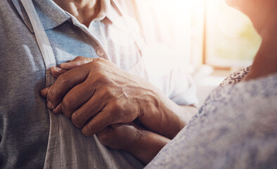 House, holding hands and senior couple with love, comfort and retirement with support. Closeup, pensioner and elderly man with old woman, relationship and bonding together with compassion and care