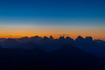 Sunset in the Dolomites beautiful landscape with mountain silhouettes and burning red light sky on the background. Sunrise and sunset in the Doloiti Alps
