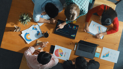 Top down view of business woman explain and present financial chart. Diverse group discuss and...