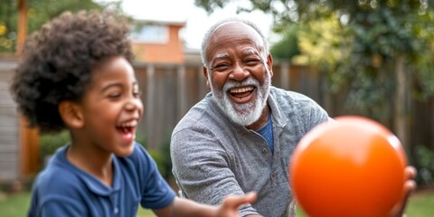 Fototapeta premium A joyful moment shared between a grandfather and grandson playing with an orange ball. Their laughter fills the air in a sunny backyard. A beautiful scene of family bonding. AI