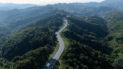 Road number three, Nan Province, aerial view of a beautiful road through the mountains full of green trees. Travel concept, transportation concept.