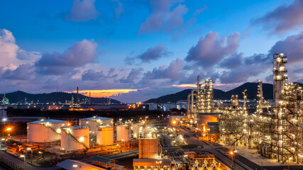 Oil and gas refinery industrial storage tank with oil and gas refinery plant at night, Refinery oil and gas power energy industrial, Oil and gas refinery petrochemical product plant pipeline steel.