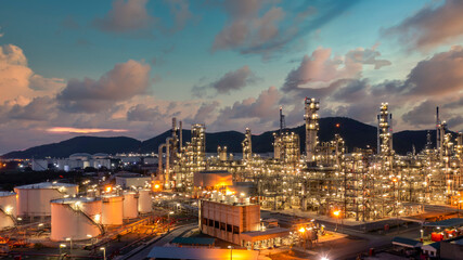 Oil and gas refinery industrial storage tank with oil and gas refinery plant at night, Refinery oil and gas power energy industrial, Oil and gas refinery petrochemical product plant pipeline steel.