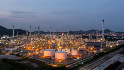 Oil and gas refinery industrial storage tank with oil and gas refinery plant at night, Refinery oil and gas power energy industrial, Oil and gas refinery petrochemical product plant pipeline steel.