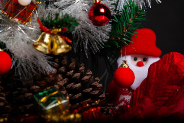 Decoration details of a Christmas tree decorated in red and gold.