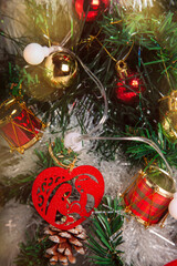 Decoration details of a Christmas tree decorated in red and gold.