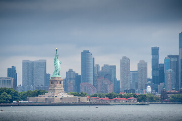 Manhattan skyline panorama with the Liberty island and the statue of liberty in the foreground