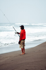 A Fisherman’s Quiet Moment by the Waves