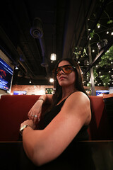 Woman with glasses eating food in the restaurant. Luxury woman.