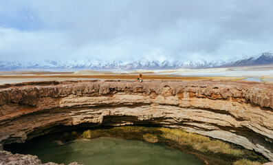 One Asian woman enjoying beautiful autumn scenery of the Mugi volcano crater Scenic Area on the Pamir Plateau in Kashgar, Xinjiang, China © sweetriver