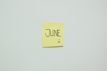 June sign on a sticky note.