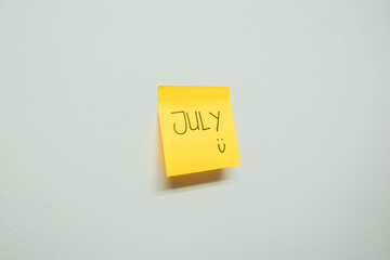 July sign on a sticky note.