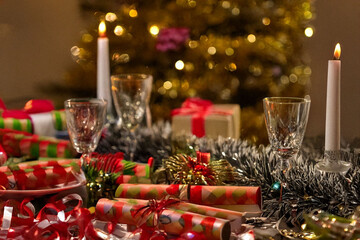A festive Christmas table setting with a roasted turkey, colorful decorations, and sparkling crackers.