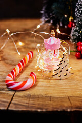 Christmas cane, garland, wooden tree and New Year's carousel in a warm holiday atmosphere