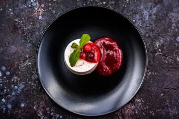 Vanilla Panna Cotta with Berry Coulis and Mint Garnish