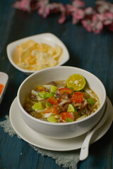 Mie kocok Bandung, Indonesian beef noodle soup served with emping crackers and chili sauce. 