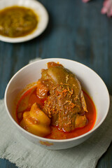 Beef leg curry or popular in Indonesia as Gulai Tunjang in a bowl
