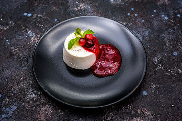 Vanilla Panna Cotta with Berry Coulis and Mint Garnish