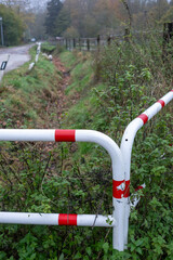White metal barrier protecting small ditch along country road