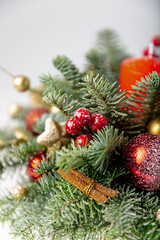 Decorated christmas tree with ornaments and lights, white background for festive holiday designs. Beautiful Christmas wreath decorated with pine cones, berries, red and golden balls