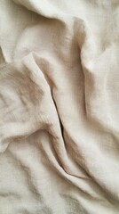 A close-up of soft, wrinkled linen fabric in a neutral beige tone, perfect for textile and design background.
