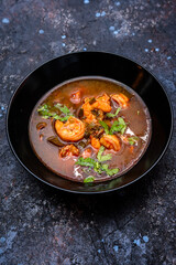 Spicy Seafood Soup with Fresh Cilantro Garnish
