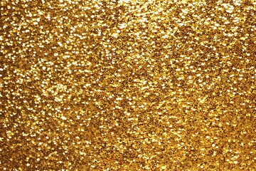 a close up of a gold glitter background with a lot of small dots