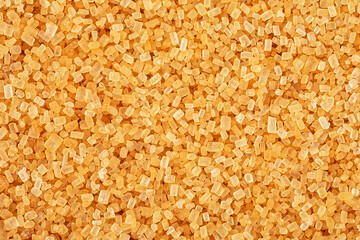 Granulated brown cane sugar as background, top view. Brown raw sugar demerara.