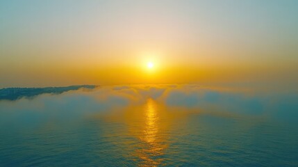 Naklejka premium A sunrise over the ocean with clouds and reflections in the water.