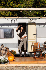 Happy n woman standing near camper van