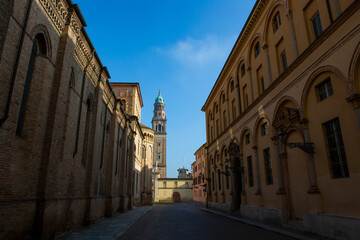 Historic street in Parma leading to the Baptistery at Piazza del Duomo, highlighting architectural charm