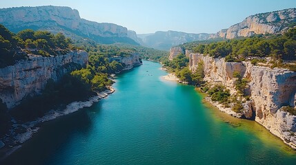 Obraz premium Serene View of a Turquoise River Flowing Through Rocky Cliffs and Lush Green Forests in a Scenic Natural Landscape Under Clear Blue Skies