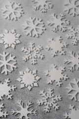 White snowflakes on a gray background