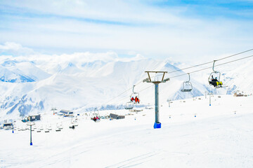 Gudauri, Georgia - 15th march , 2022 - skier sit on ski lift go up mountain in ski resort. Skiing,...