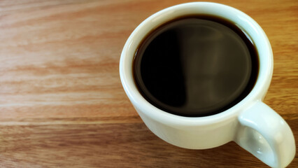 Coffee cup with on the wooden table.	
